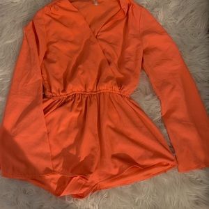 Orange romper with wide bell sleeves